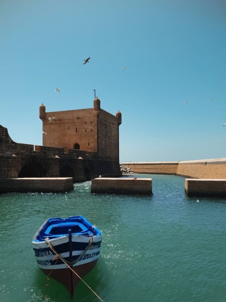fortress and blue boat in essaouira morocco
